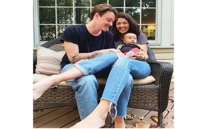 Ellen Tamaki smiling in a grey t-shirt and blue jeans with her boyfriend in a black t-shirt and blue jeans.